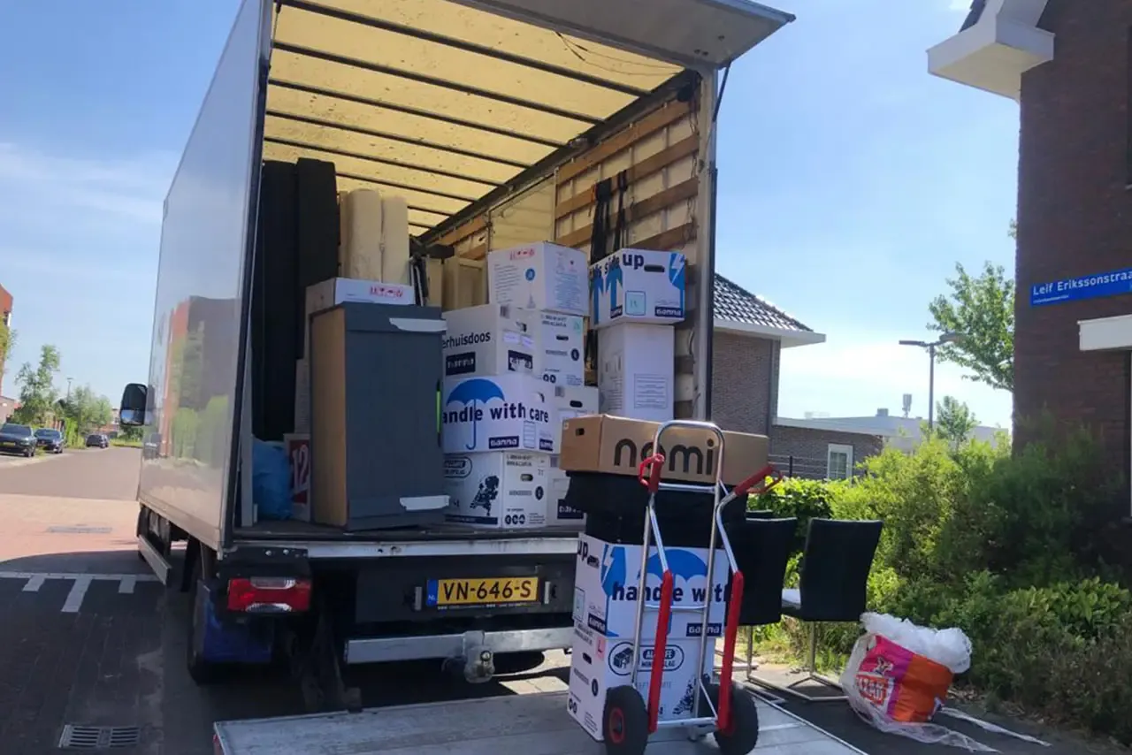 Volgeladen verhuiswagen van Busje komt zo, klaar om te vertrekken